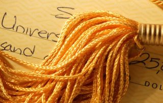 college tuition check and graduation tassel