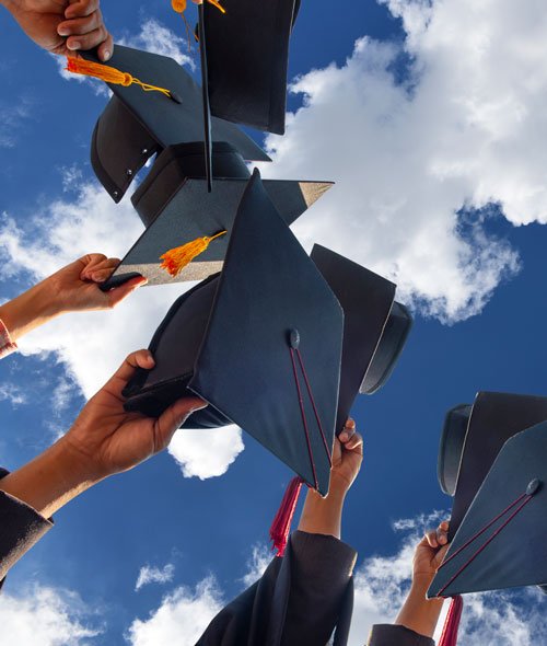 graduation-celebration Image of graduation caps against a partly cloudy sky